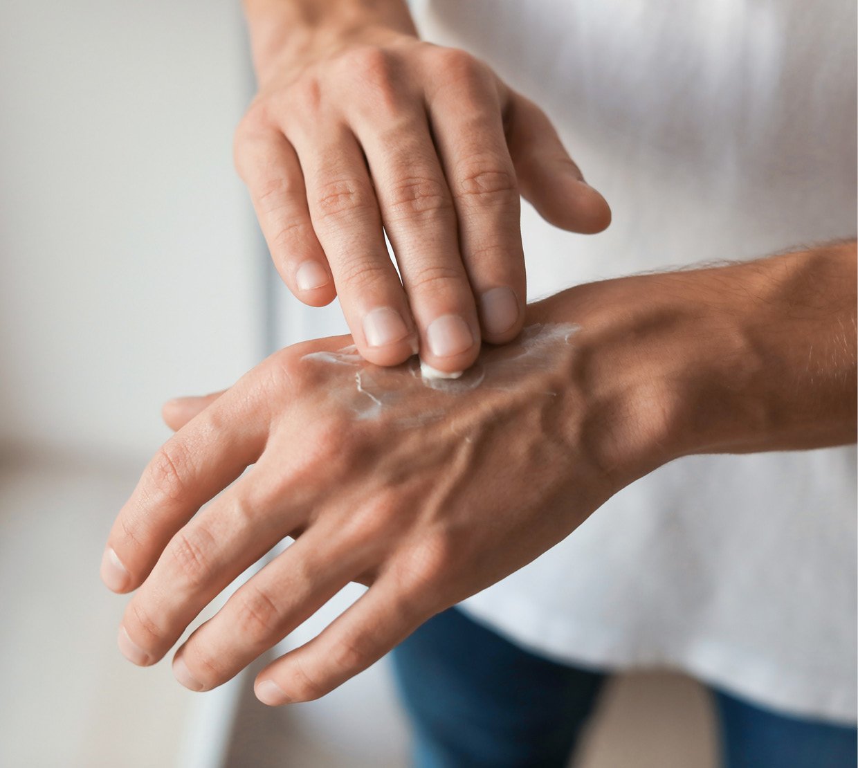 Cosmetic Services - man is putting cream on his hands