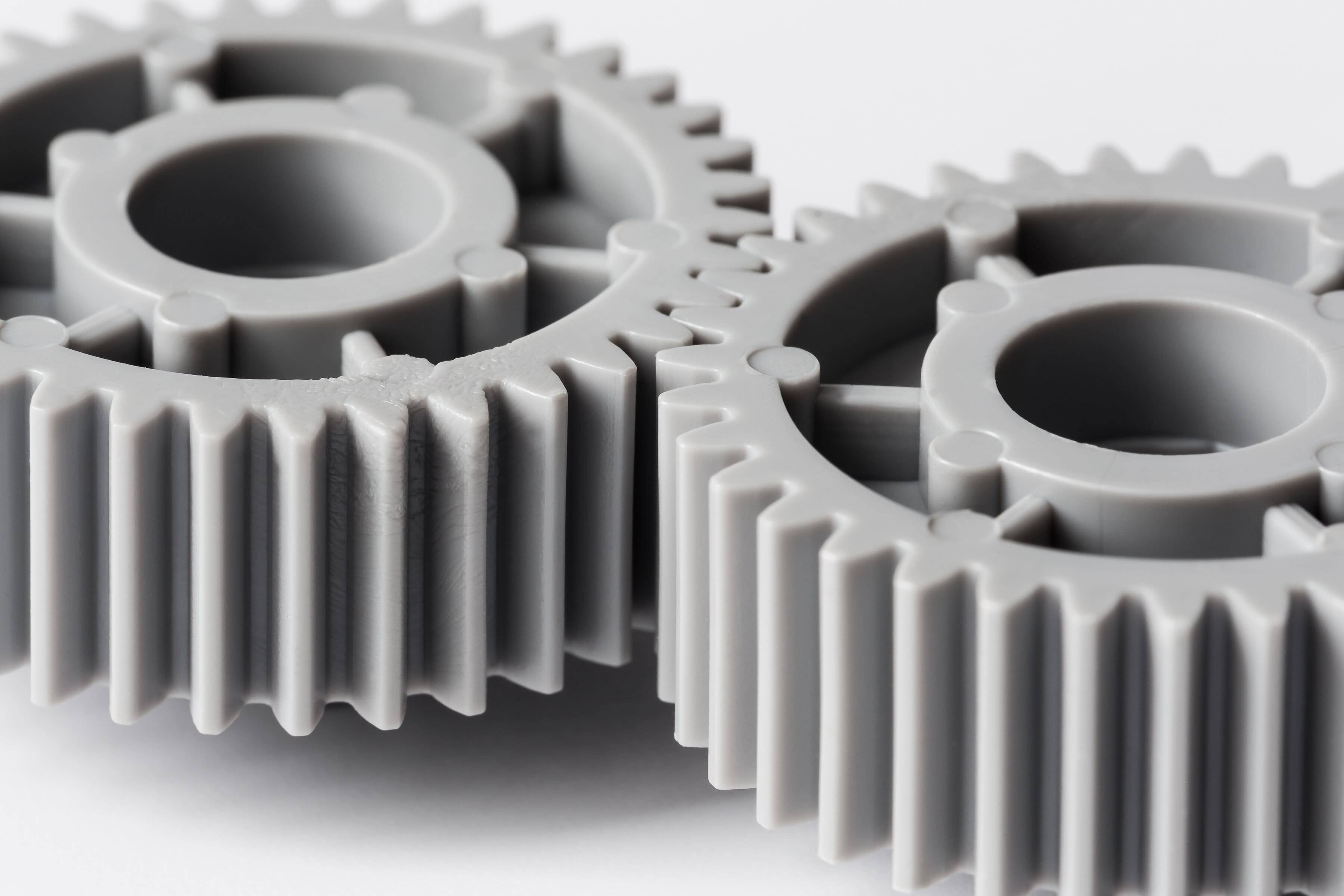 EnergyCuring Product News - two plastic gears closeup geared for one another