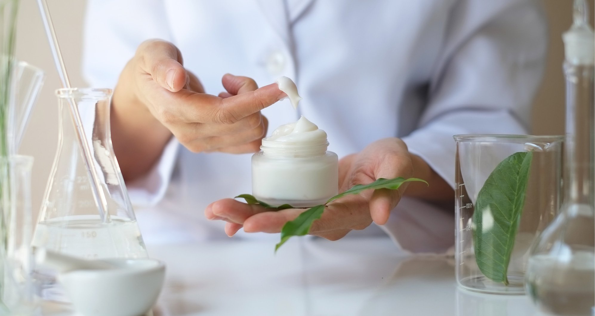 cosmetic ingredients supplier - person in a lab holding a cream