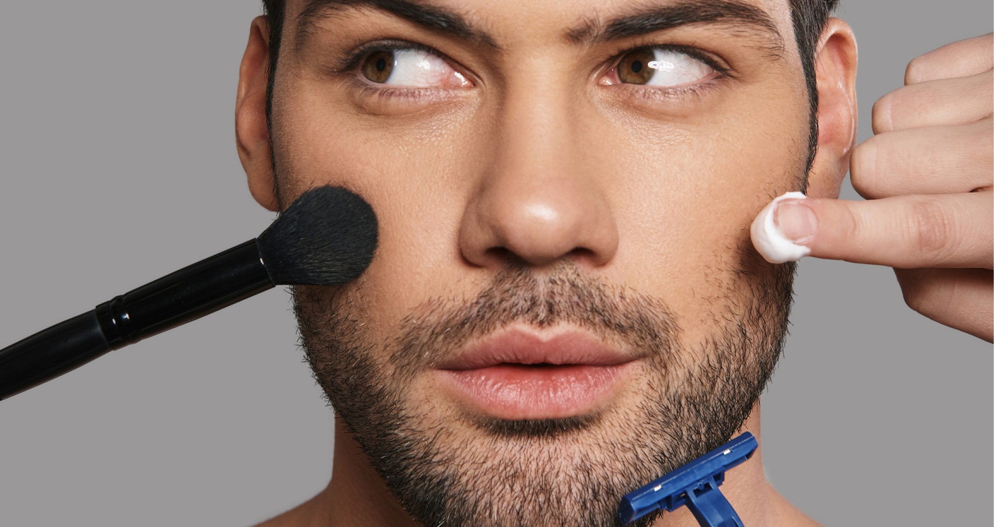 Cosmetic Services - face of a young man, he is getting a brush, a razor and lotion held to his face