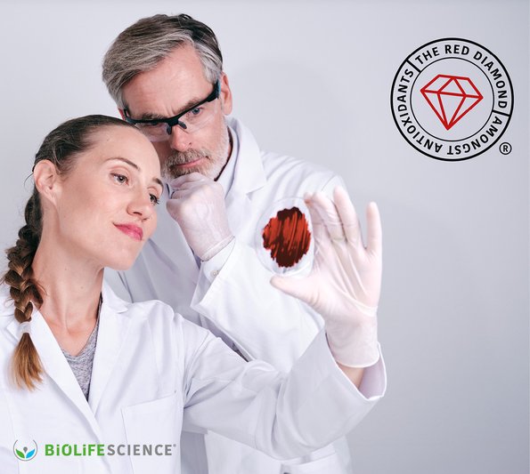 cosmetic webinar - a man and a woman in lab coats looking at something red